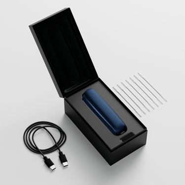 Ploom AURA open box showing the device, its charging cable and cleaning sticks.