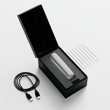 Ploom AURA open box showing the device, its charging cable and cleaning sticks.