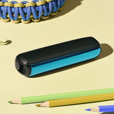 Close-up of a Ploom AURA front panel Ocean Blue accessory on a desk.