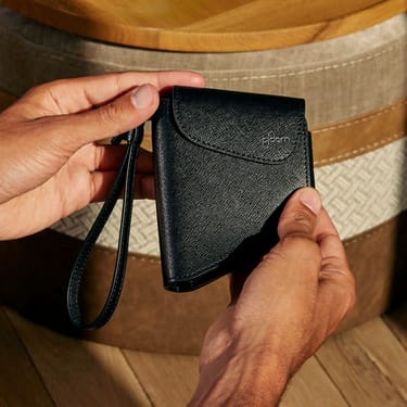 Hand holding a Ploom Duo Carry Case Jet Black accessory