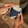 Hand holding a Ploom Duo Carry Case Denim Leather Fusion accessory