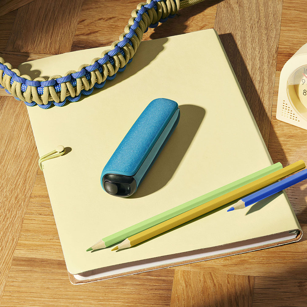 Ploom device with Ocean Blue Back Cover on notebook