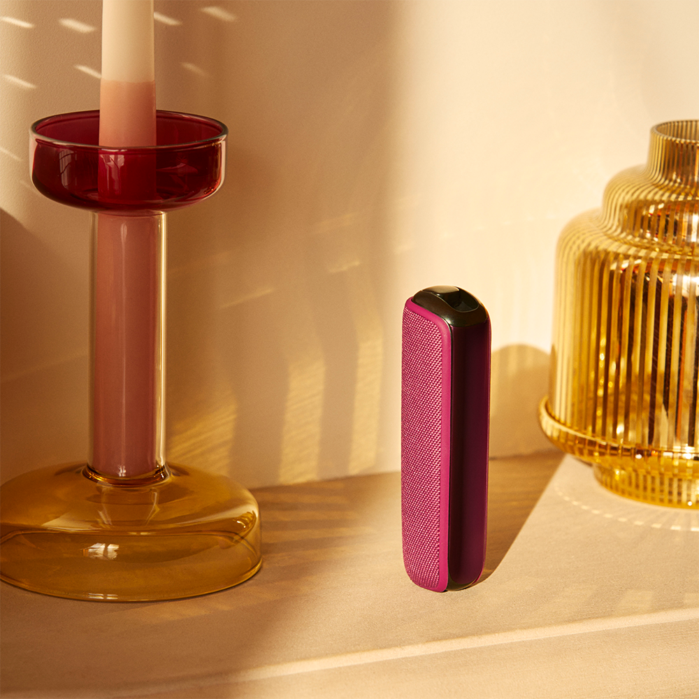 ploom-aura-dark-orchid-device-standing-table